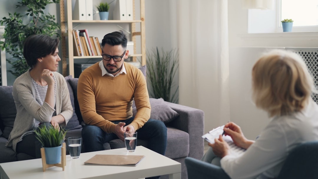 Man and woman at therapy session with counselor.